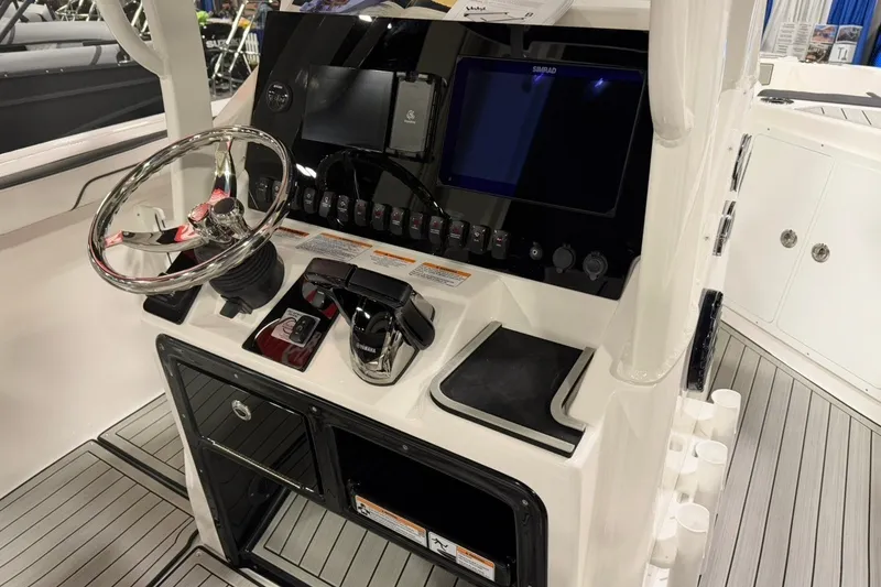 Slide: The Image of 2025 Yamaha Boats 255 FSH Sport E helm with steering wheel and control panel. - 8