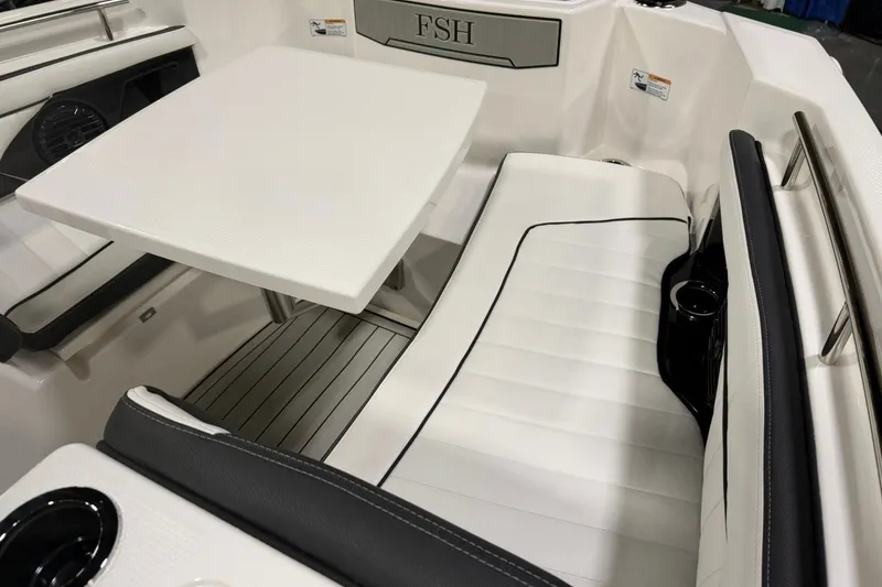 Slide: The Image of 2025 Yamaha Boats 255 FSH Sport E interior with seating and table. - 16