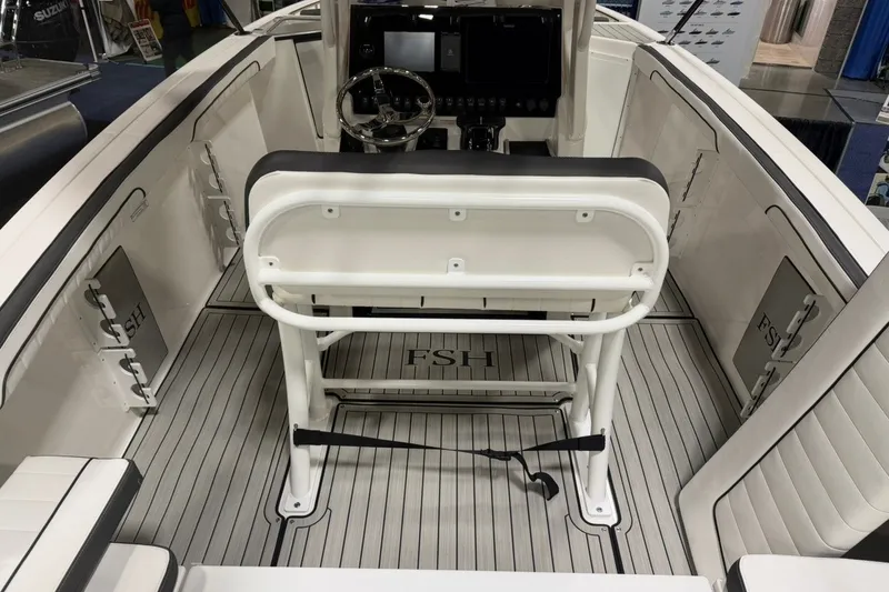 Slide: The Image of 2025 Yamaha Boats 255 FSH Sport E interior with helm and seating area. - 7