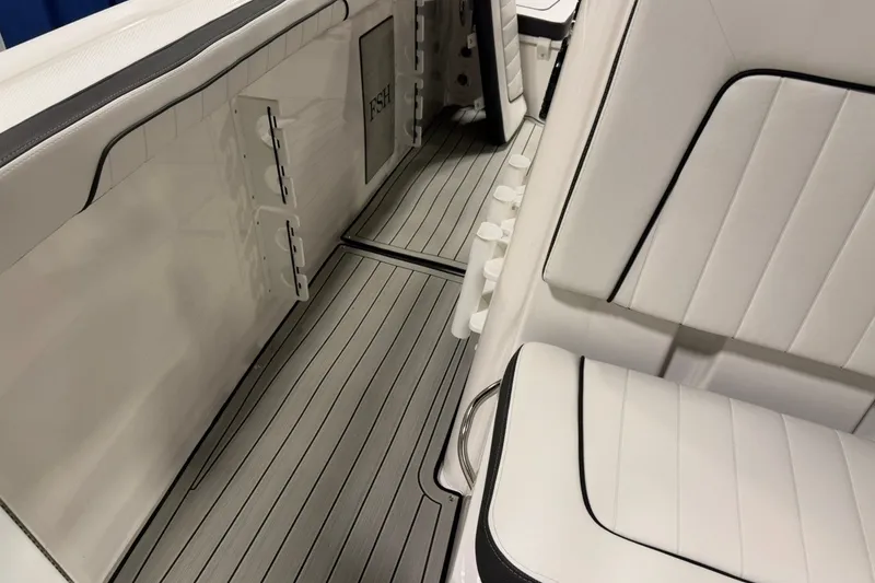 Slide: The Image of 2025 Yamaha Boats 255 FSH Sport E interior with sleek white seating and modern design. - 21