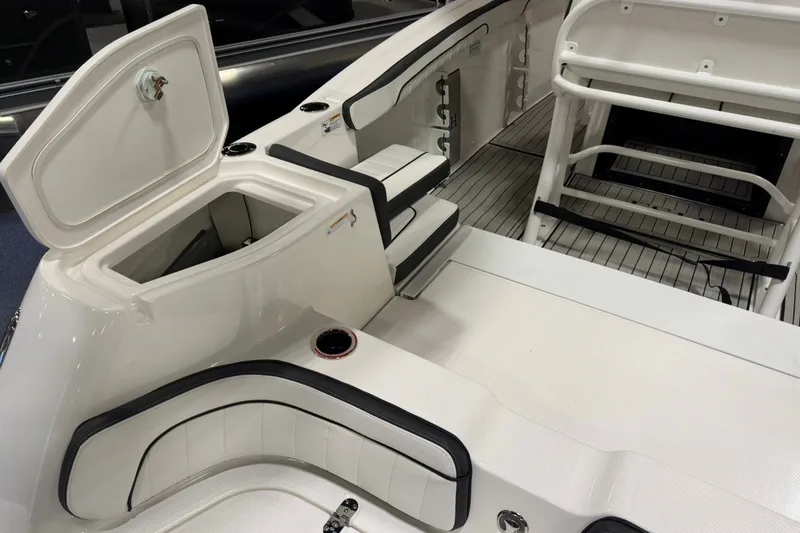 Slide: The Image of 2025 Yamaha Boats 255 FSH Sport E interior with storage compartment and seating. - 5