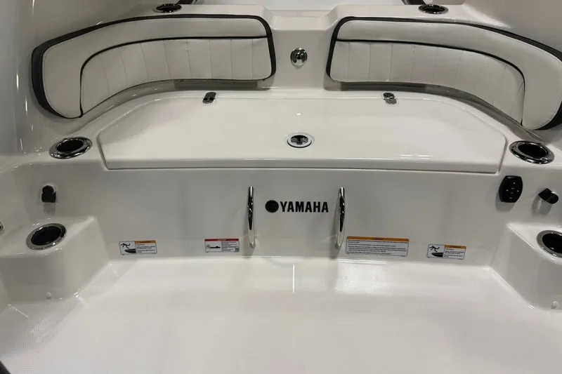 Slide: The Image of 2025 Yamaha Boats 255 FSH Sport E interior with seating and cup holders. - 4