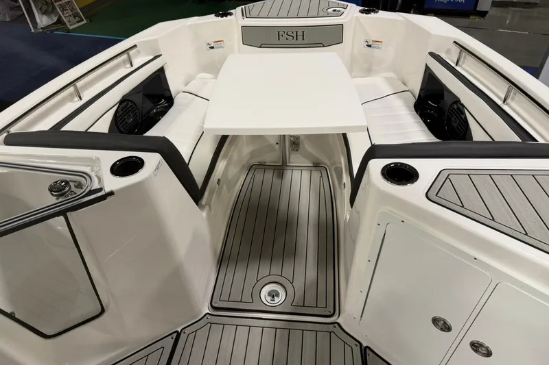 Slide: The Image of 2025 Yamaha Boats 255 FSH Sport E interior with seating and table, showcasing modern design. - 15