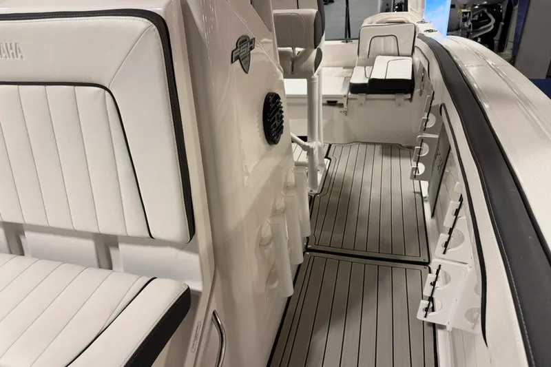 Slide: The Image of 2025 Yamaha Boats 255 FSH Sport E interior with sleek seating and modern design. - 22