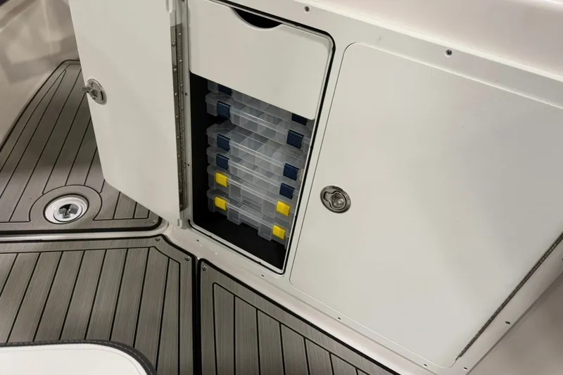 Slide: The Image of Storage compartment with tackle boxes on 2025 Yamaha Boats 255 FSH Sport E. - 14
