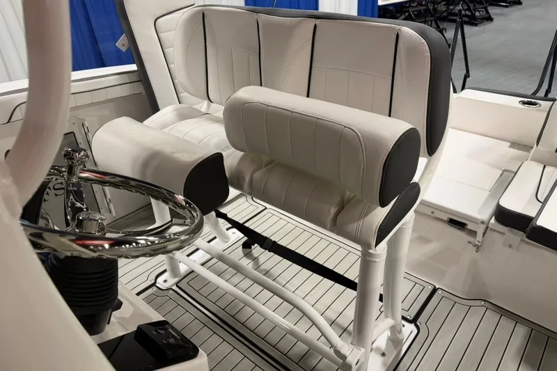 Slide: The Image of 2025 Yamaha Boats 255 FSH Sport E interior with white seating and steering wheel. - 23