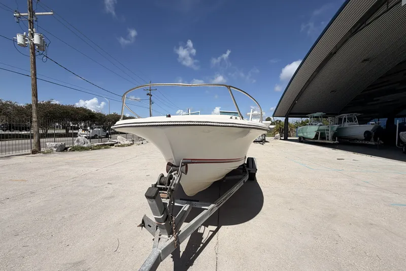 Slide: The Image of 1988 Wellcraft 200 Fisherman boat on trailer, parked outdoors under clear blue sky. - 7
