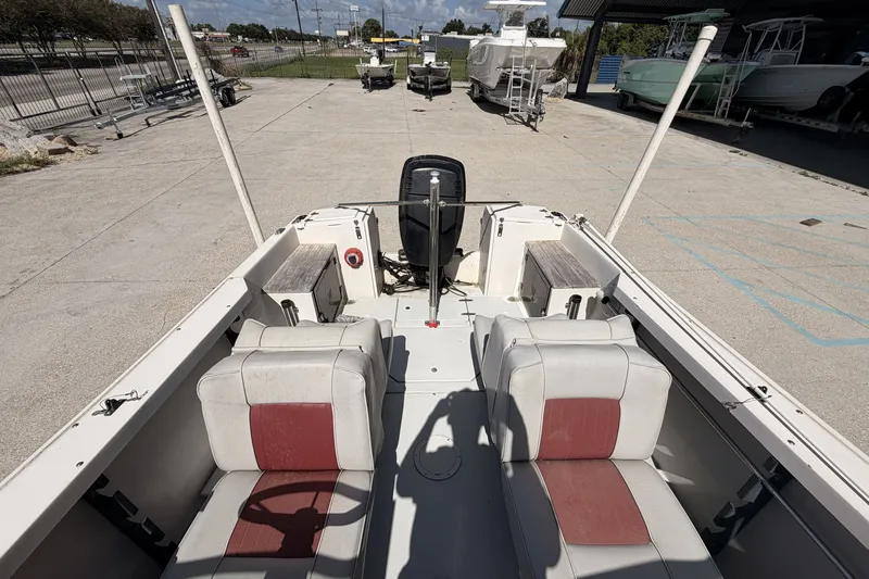 Slide: The Image of 1988 Wellcraft 200 Fisherman boat interior with dual seats and outboard motor in a marina setting. - 12