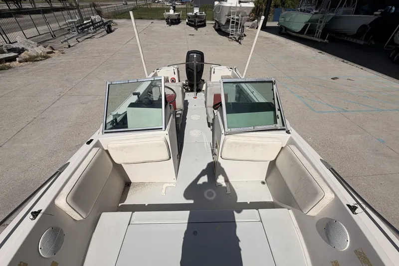 Slide: The Image of 1988 Wellcraft 200 Fisherman boat interior with seating and console, parked outdoors. - 11