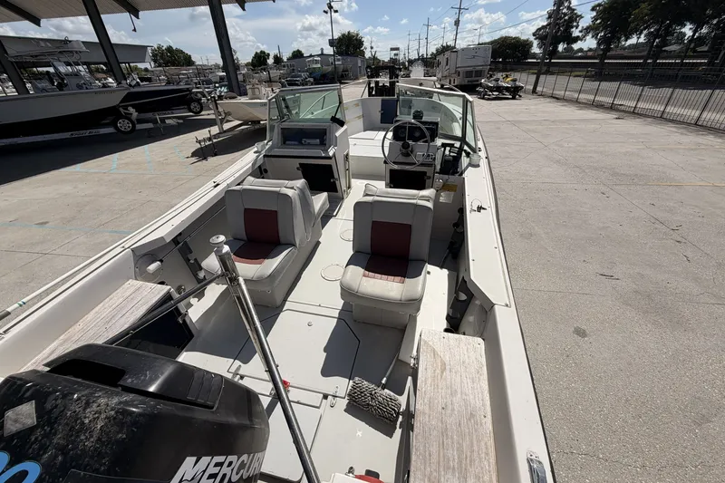 Slide: The Image of 1988 Wellcraft 200 Fisherman boat with dual seats and Mercury engine, parked outdoors. - 8