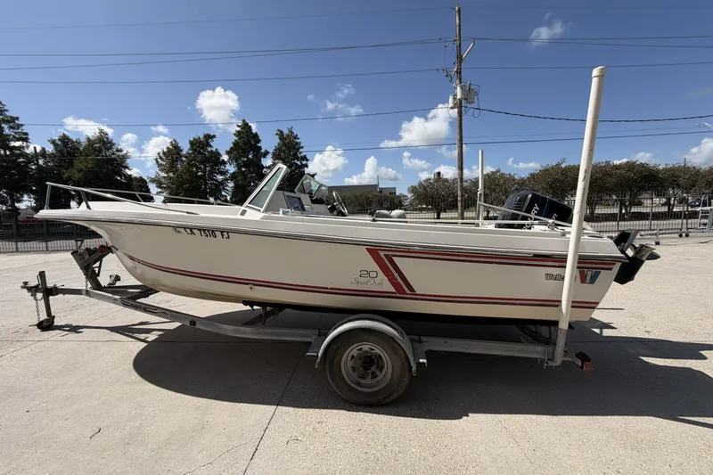 Slide: The Image of 1988 Wellcraft 200 Fisherman boat on trailer, parked outdoors under a clear blue sky. - 5