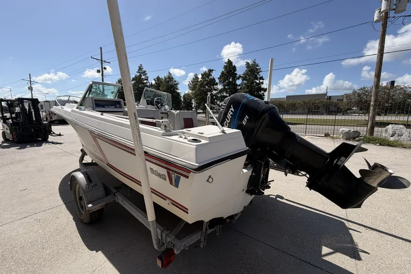 Slide: The Image of 1988 Wellcraft 200 Fisherman boat with Mercury engine on trailer, parked outdoors. - 4