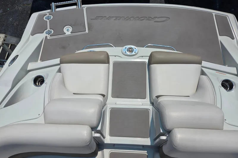 Slide: The Image of 2015 Crownline 255 SS boat interior with cushioned seating and deck details. - 31