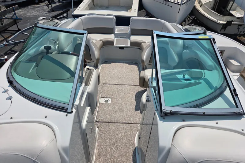 Slide: The Image of 2015 Crownline 255 SS boat interior with seating and windshield. - 18