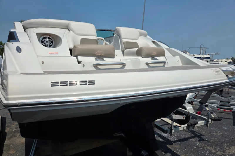 Slide: The Image of 2015 Crownline 255 SS boat on trailer, rear view, white exterior. - 9