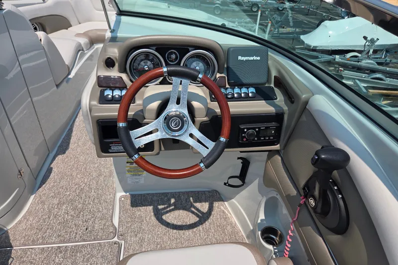 Slide: The Image of 2015 Crownline 255 SS boat dashboard with steering wheel and controls. - 14