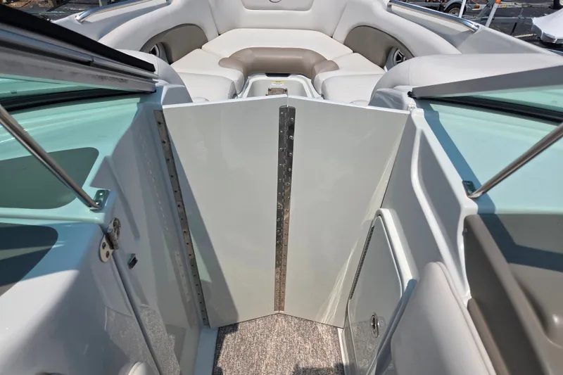 Slide: The Image of Interior view of 2015 Crownline 255 SS boat with seating and open door. - 19