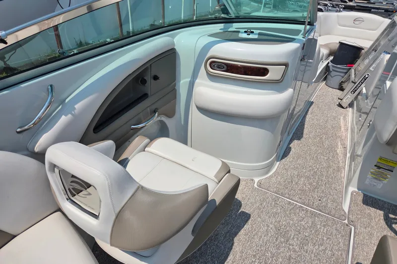 Slide: The Image of 2015 Crownline 255 SS boat interior with seating and storage compartments. - 23