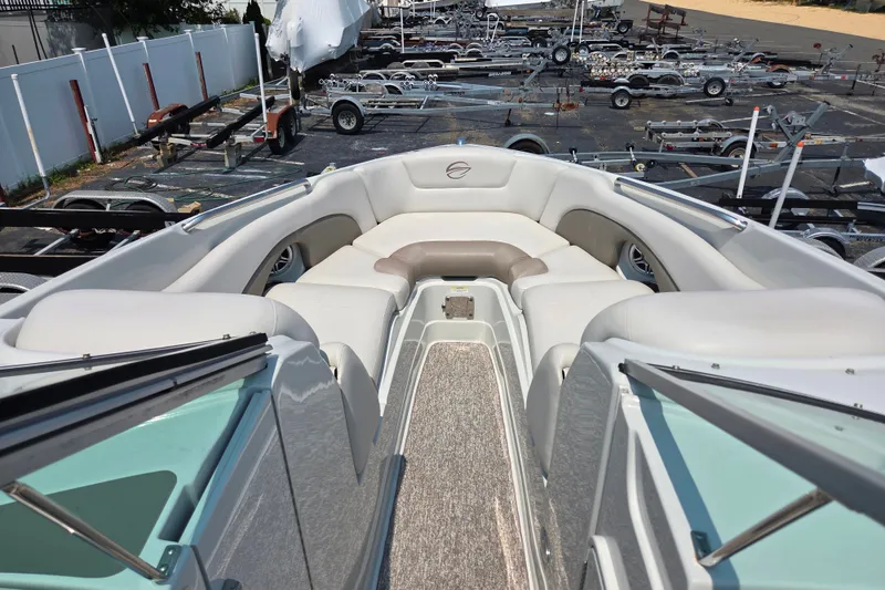 Slide: The Image of 2015 Crownline 255 SS boat interior with plush seating and carpeted flooring. - 15