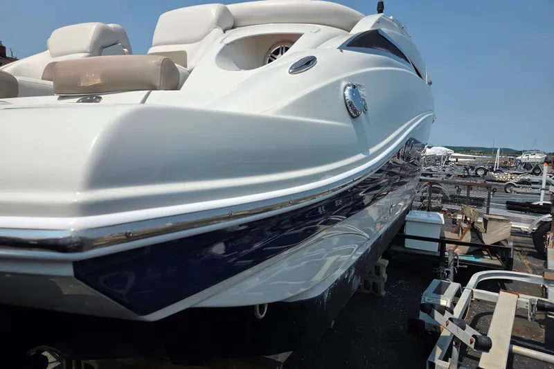 Slide: The Image of 2015 Crownline 255 SS boat on trailer, showcasing sleek design and luxurious seating. - 34