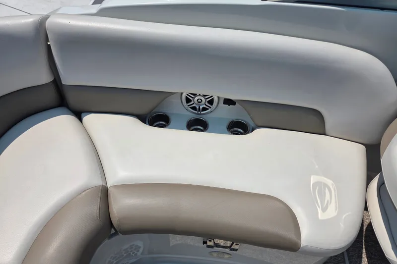 Slide: The Image of 2015 Crownline 255 SS boat interior with cushioned seating and cup holders. - 26