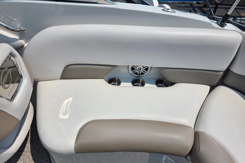 Slide: The Image of 2015 Crownline 255 SS boat interior with cushioned seating and cup holders. - 27