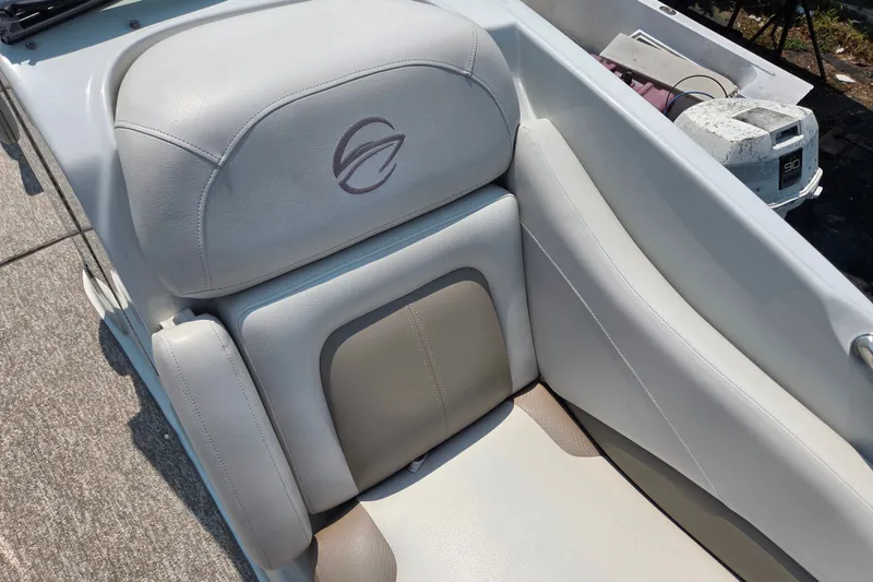 Slide: The Image of 2015 Crownline 255 SS boat seat with logo, featuring light gray upholstery. - 21