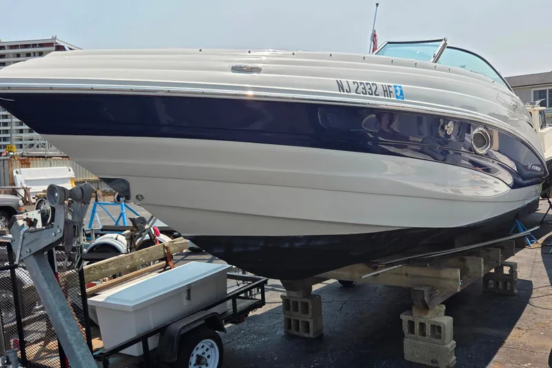Slide: The Image of 2015 Crownline 255 SS boat on trailer, docked in marina setting. - 12