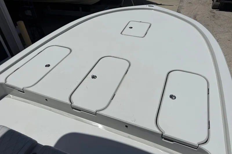 Slide: The Image of 2027 Shallow Sport 25 X3 boat deck with storage compartments. - 15