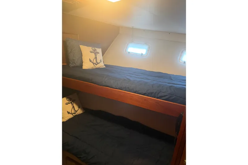 Slide: The Image of Bunk beds with nautical-themed pillows in 1981 Hatteras 56 Motor Yacht cabin. - 19