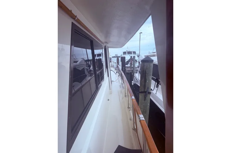 Slide: The Image of 1981 Hatteras 56 Motor Yacht docked, showcasing side deck and railing. - 3