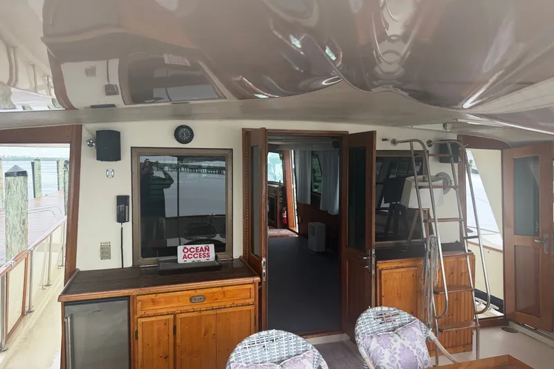 Slide: The Image of Interior view of 1981 Hatteras 56 Motor Yacht with wooden cabinetry and ocean access sign. - 23
