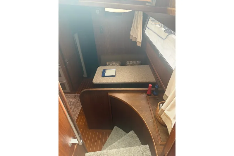 Slide: The Image of Interior view of 1981 Hatteras 56 Motor Yacht with wooden stairs and seating area. - 20
