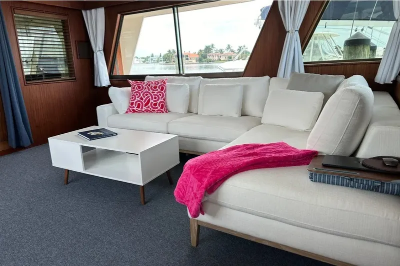 Slide: The Image of Luxurious interior of 1981 Hatteras 56 Motor Yacht with white sofa and pink accents. - 8