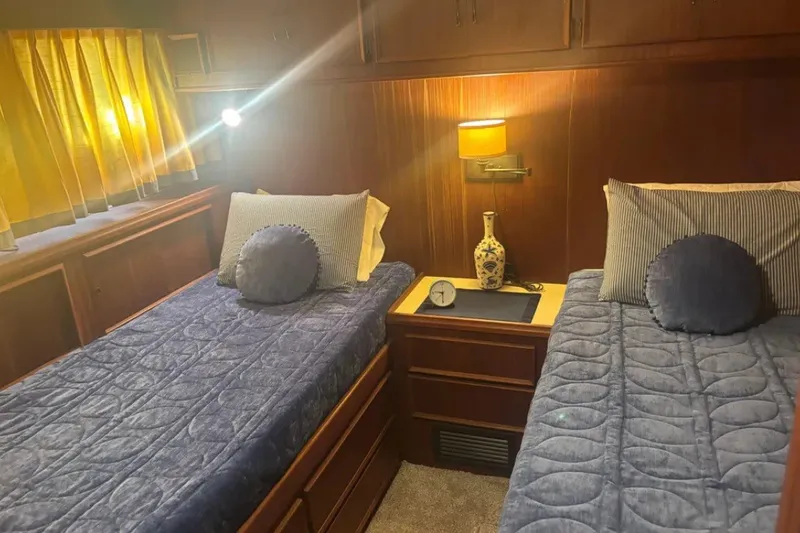 Slide: The Image of Interior of 1981 Hatteras 56 Motor Yacht with twin beds and cozy decor. - 13