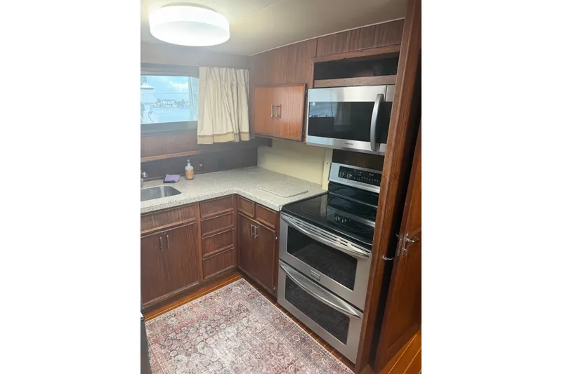 Slide: The Image of 1981 Hatteras 56 Motor Yacht kitchen with modern appliances and wood cabinetry. - 6