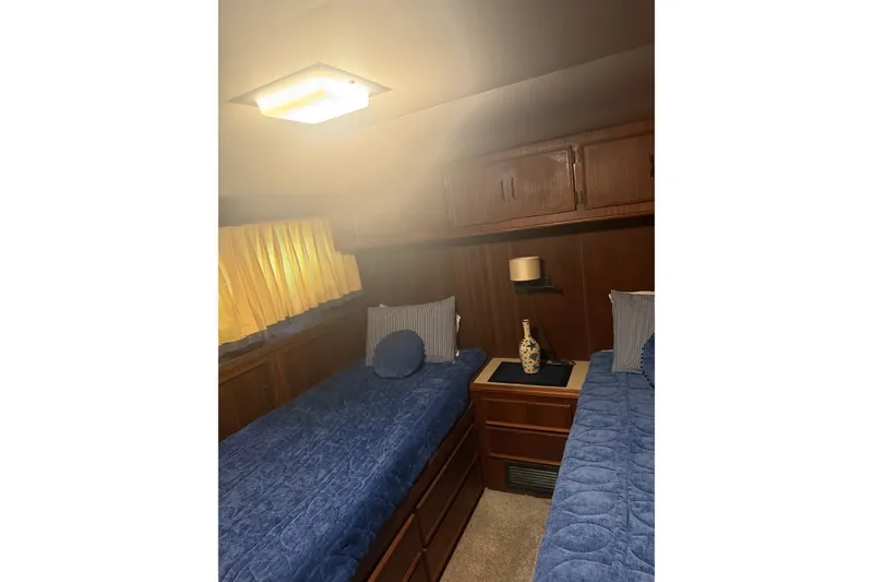 Slide: The Image of Cozy cabin interior of 1981 Hatteras 56 Motor Yacht with twin beds and wooden cabinetry. - 15