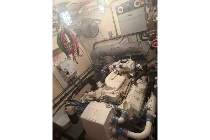 Slide: The Image of Engine room of a 1981 Hatteras 56 Motor Yacht, showcasing mechanical components. - 17