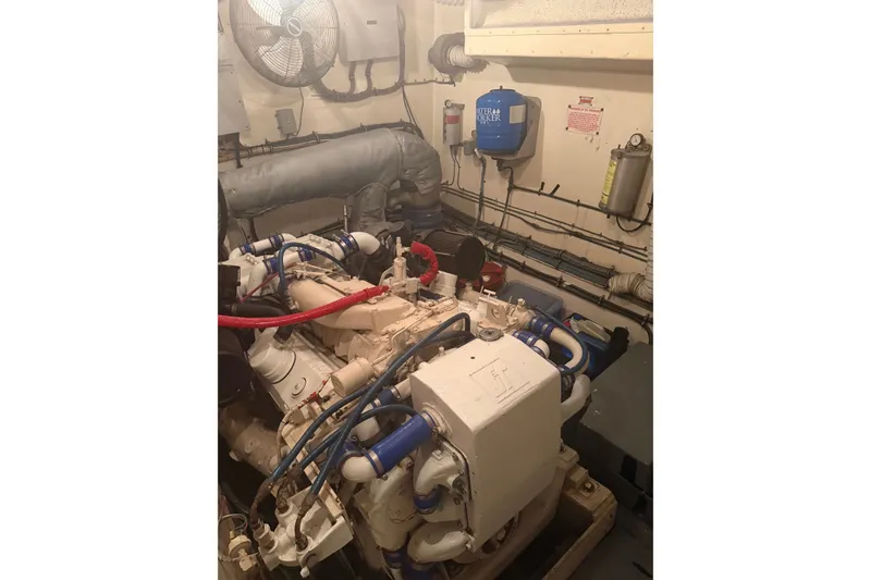 Slide: The Image of Engine room of 1981 Hatteras 56 Motor Yacht with visible machinery and piping. - 16