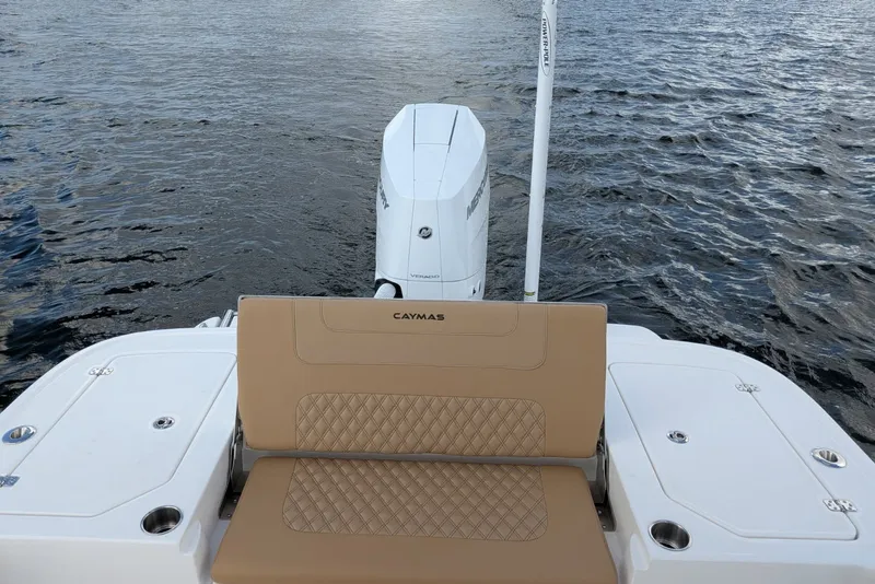 Slide: The Image of 2027 Caymas 28 HB boat with tan seating and powerful outboard motor on water. - 12