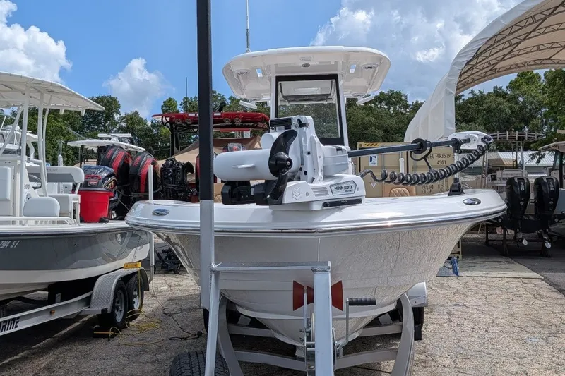 Slide: The Image of 2027 Caymas 28 HB boat on trailer, displayed outdoors under a clear sky. - 3