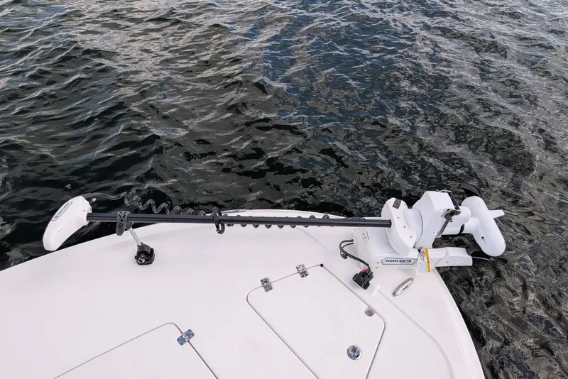 Slide: The Image of 2027 Caymas 28 HB boat with Minn Kota trolling motor on water. - 16