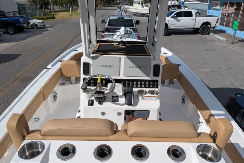 Slide: The Image of 2027 Caymas 28 HB boat interior with Garmin navigation system and tan seating. - 5