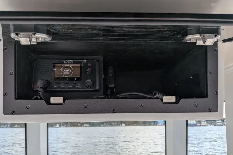 Slide: The Image of 2027 Caymas 28 HB boat with Garmin marine radio in storage compartment. - 9