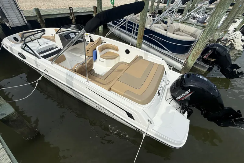Slide: The Image of 2025 Bayliner VR6 Bowrider OB docked, featuring sleek design and Mercury outboard engine. - 5