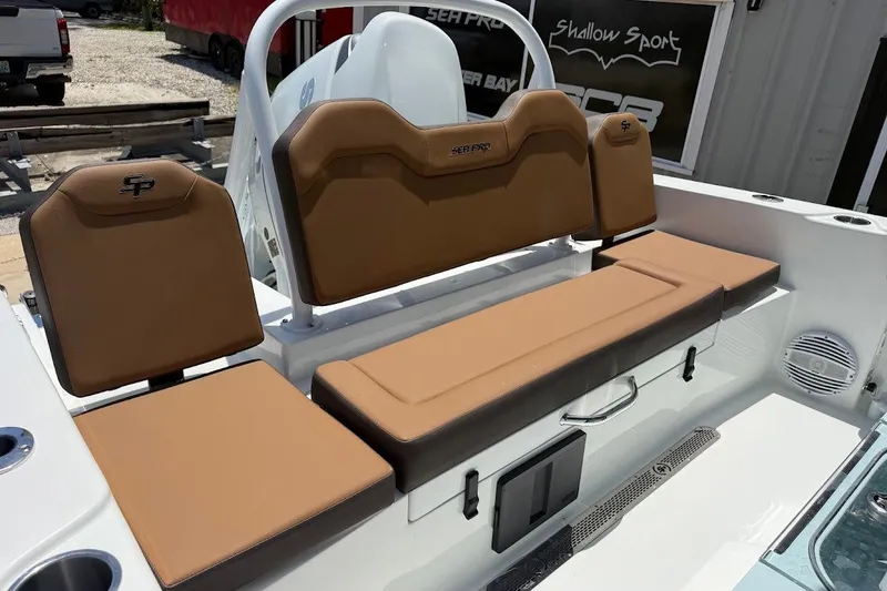 Slide: The Image of 2027 Sea Pro 245FLXR Sandbar boat interior with tan seating and storage compartments. - 17