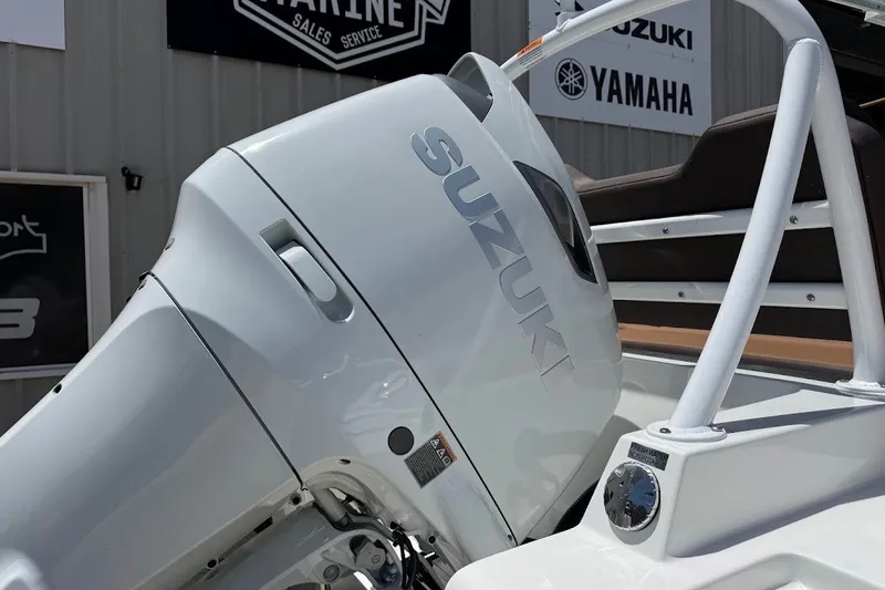 Slide: The Image of 2027 Sea Pro 245FLXR Sandbar boat with Suzuki outboard motor, displayed at a marine dealership. - 12
