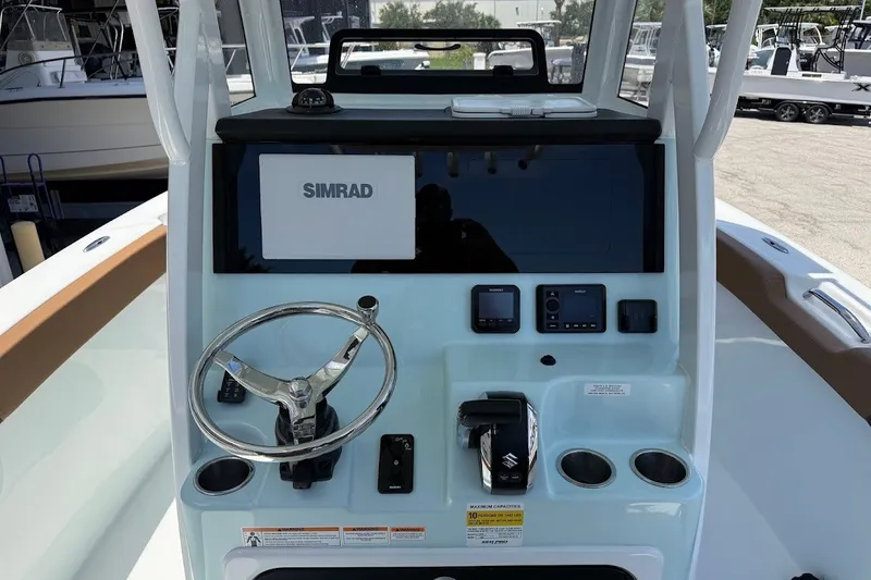 Slide: The Image of Console of 2027 Sea Pro 245FLXR Sandbar boat with Simrad display and controls. - 13