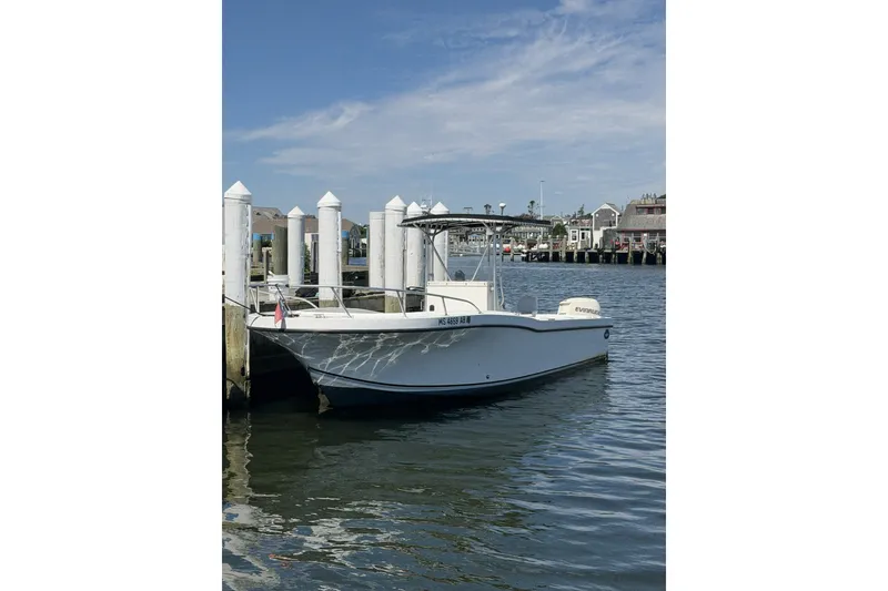 The Image of 2001 Dusky 252 Open Fisherman boat docked at a marina under a clear sky. - 0
