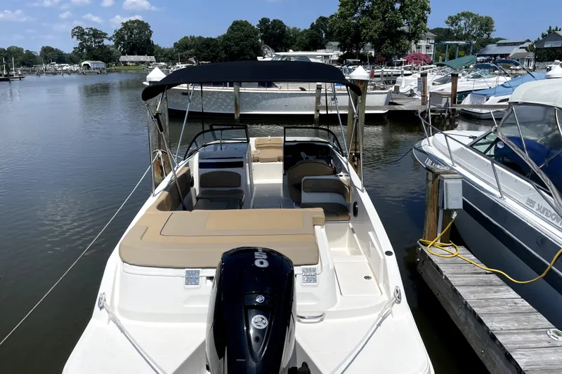 Slide: The Image of 2025 Bayliner VR6 Bowrider OB docked at marina, featuring spacious seating and outboard motor. - 3